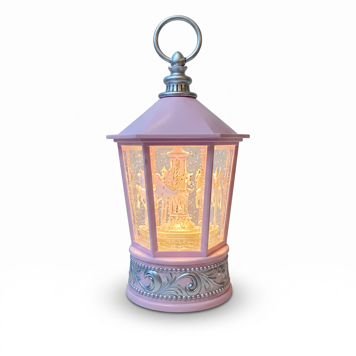Farol navideño rosado con luz cálida y escena interior